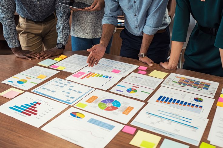Consulting team reviewing charts and strategy documents